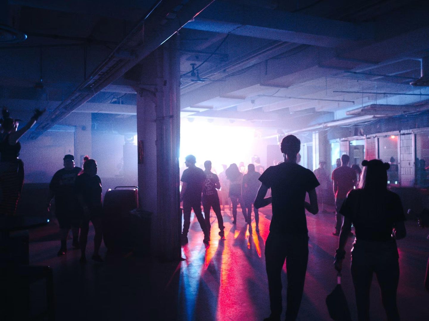 Dance floor glowing in neon pink and purple