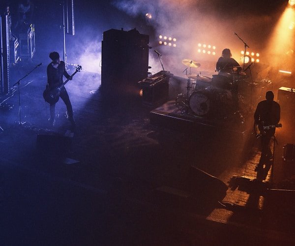 Band playing under purple and orange stage lights