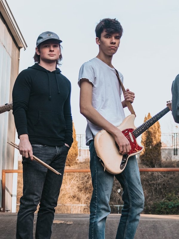 Local band posing with their guitar before a Live Stage set